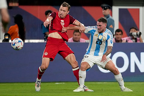 Alistair Johnston and Alexis Mac Allister battle for the ball 